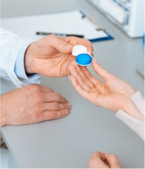 Doctor handing over contact lenses case 