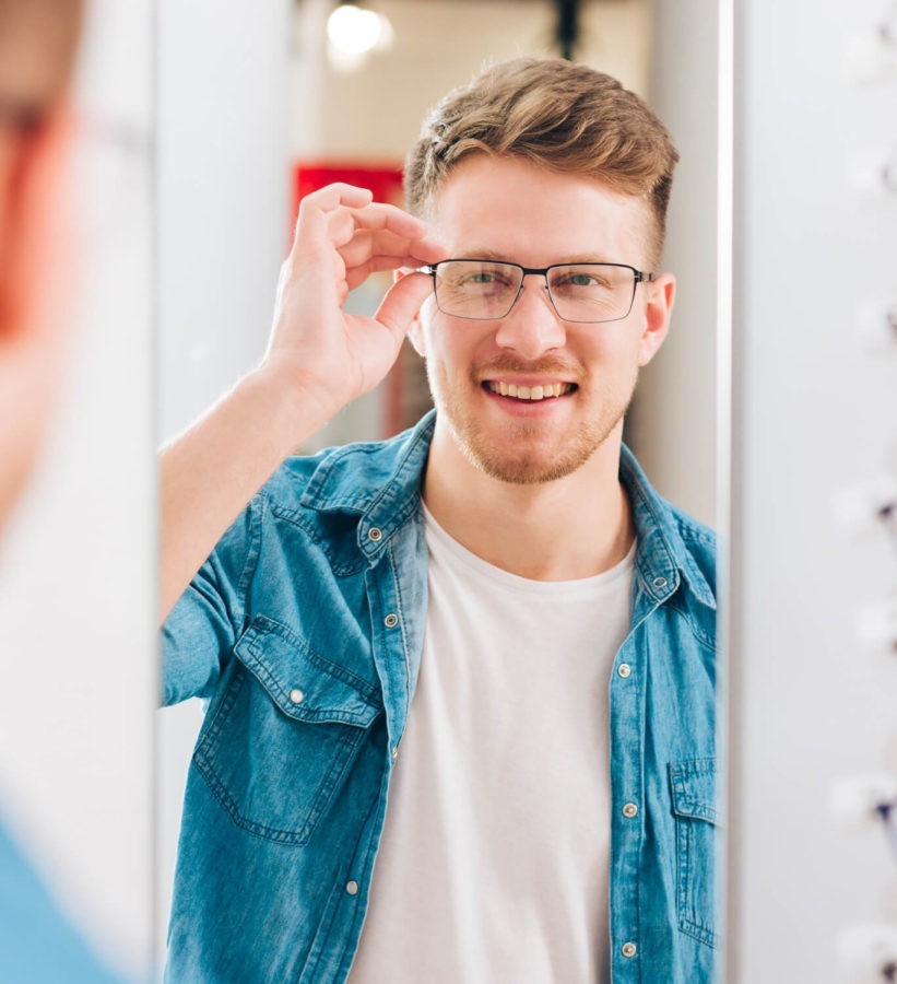 Man trying on eyeglasses at Eyemart