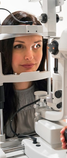 Woman getting a contact lens exam at Eyemart Optical in IA