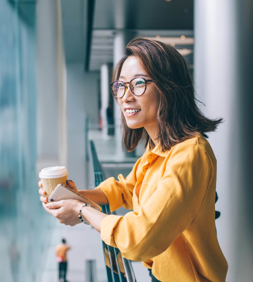 Woman in eyeglasses enjoying her coffee
