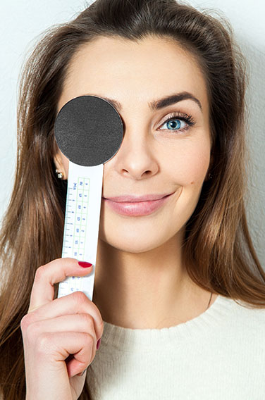 Woman holding eye check-up equipment